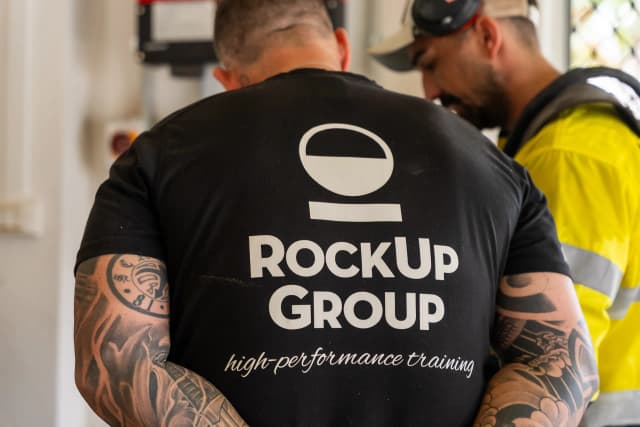 Daniel McKellar speaking with a training instructor about concrete grinding techniques