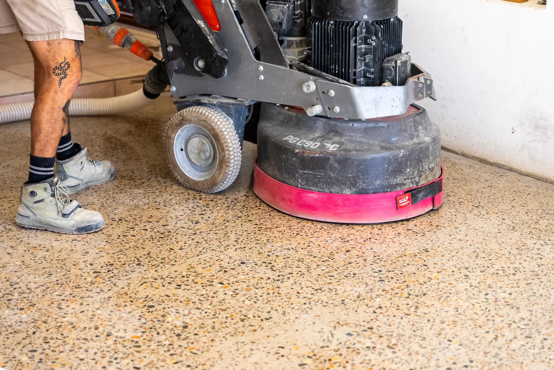 Mid-shot of the honed concrete floor with the Husqvarna grinding machine