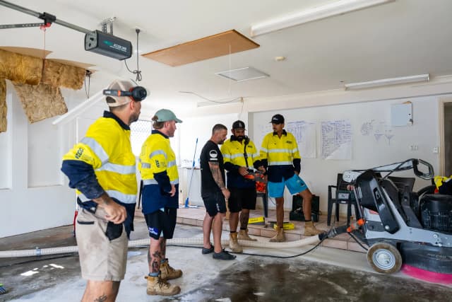 ICGC team members examining a Husqvarna concrete grinding machine during training