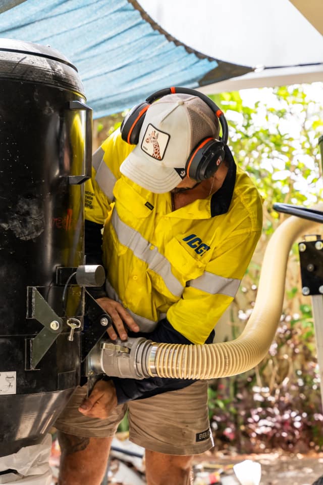 ICGC team member fitting the exhaust system to a Husqvarna concrete grinding machine