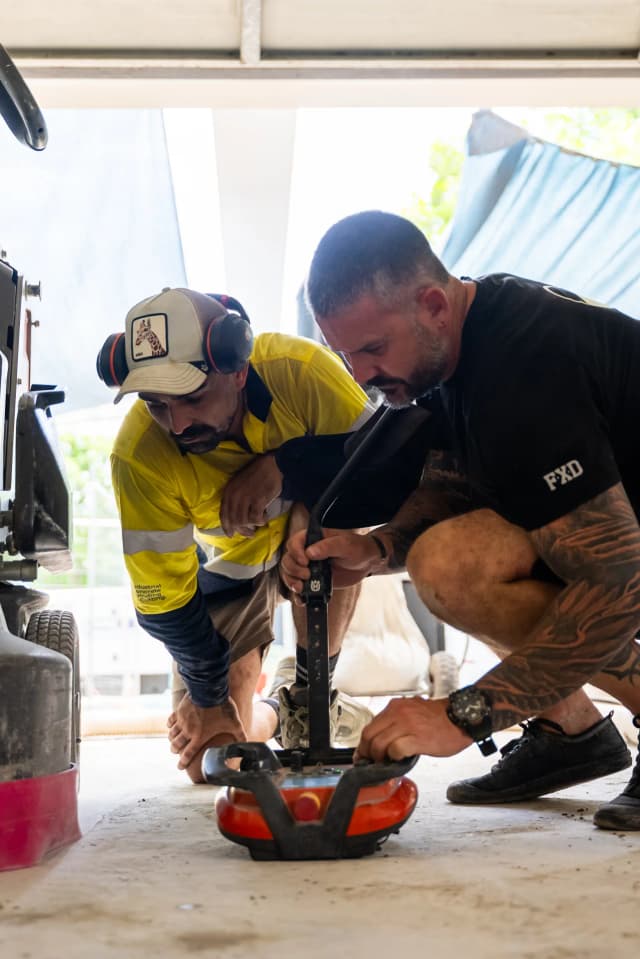 ICGC team members in hands-on learning session with concrete grinding equipment