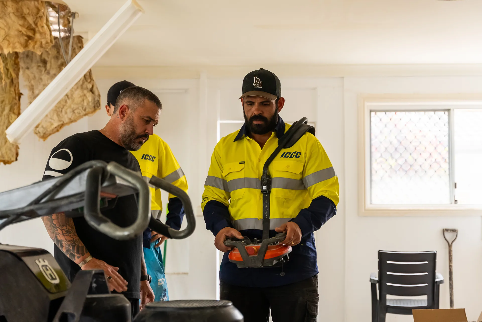 Instructor demonstrating the Husqvarna remote control system to ICGC team