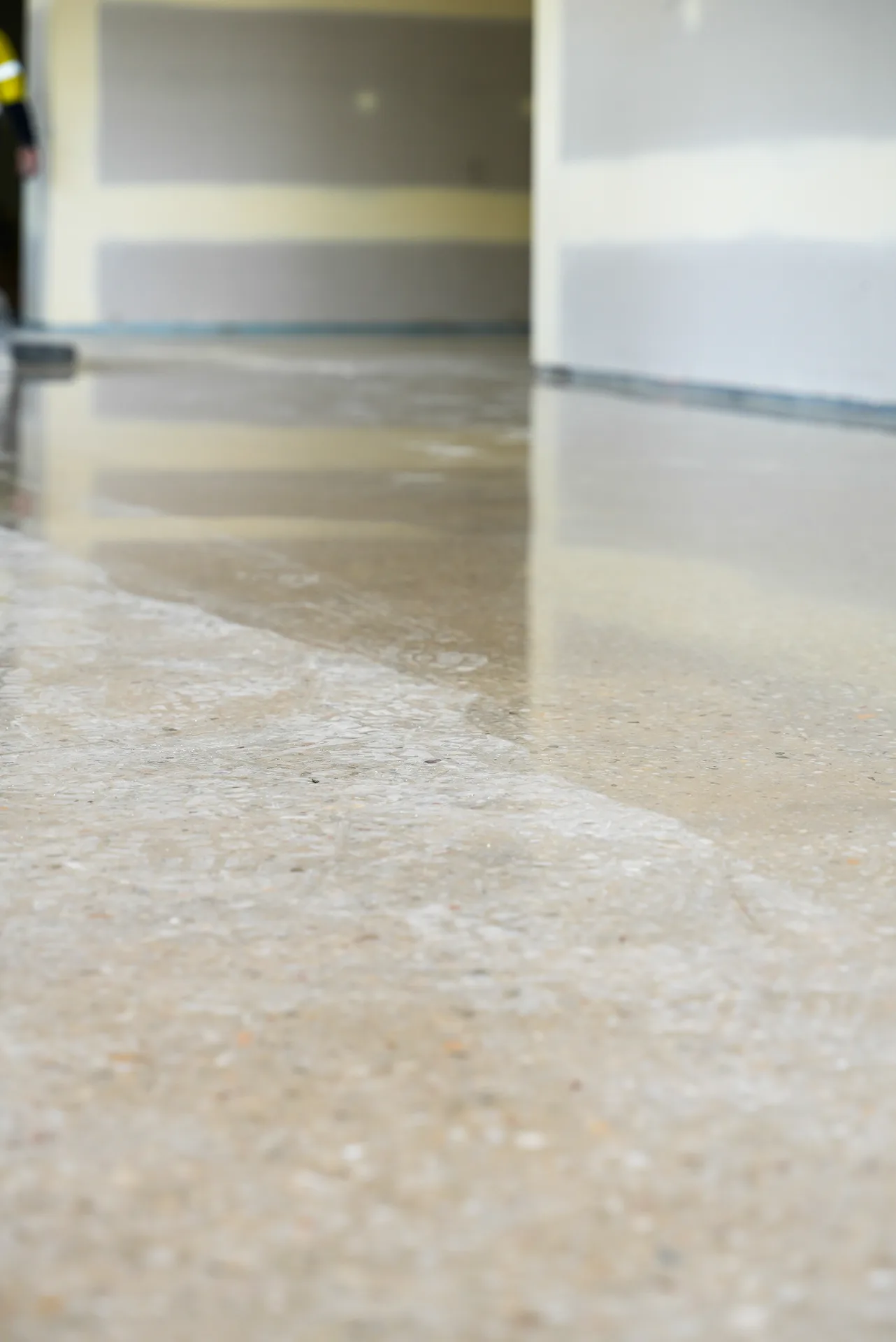 Close-up of finished polished concrete floor in a Brisbane commercial space showing high gloss and light reflection