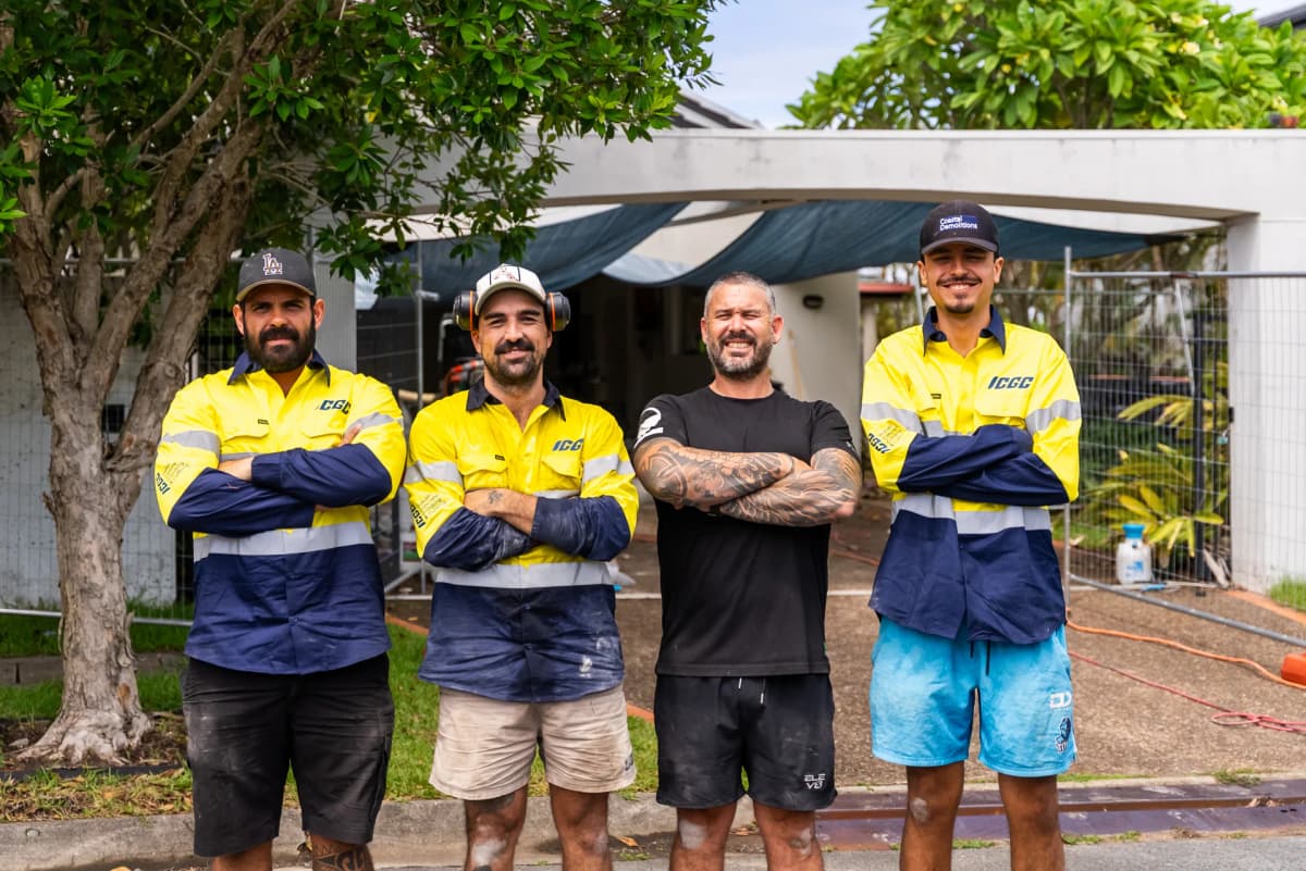 ICGC team and Husqvarna instructors posing with arms crossed and smiling at camera