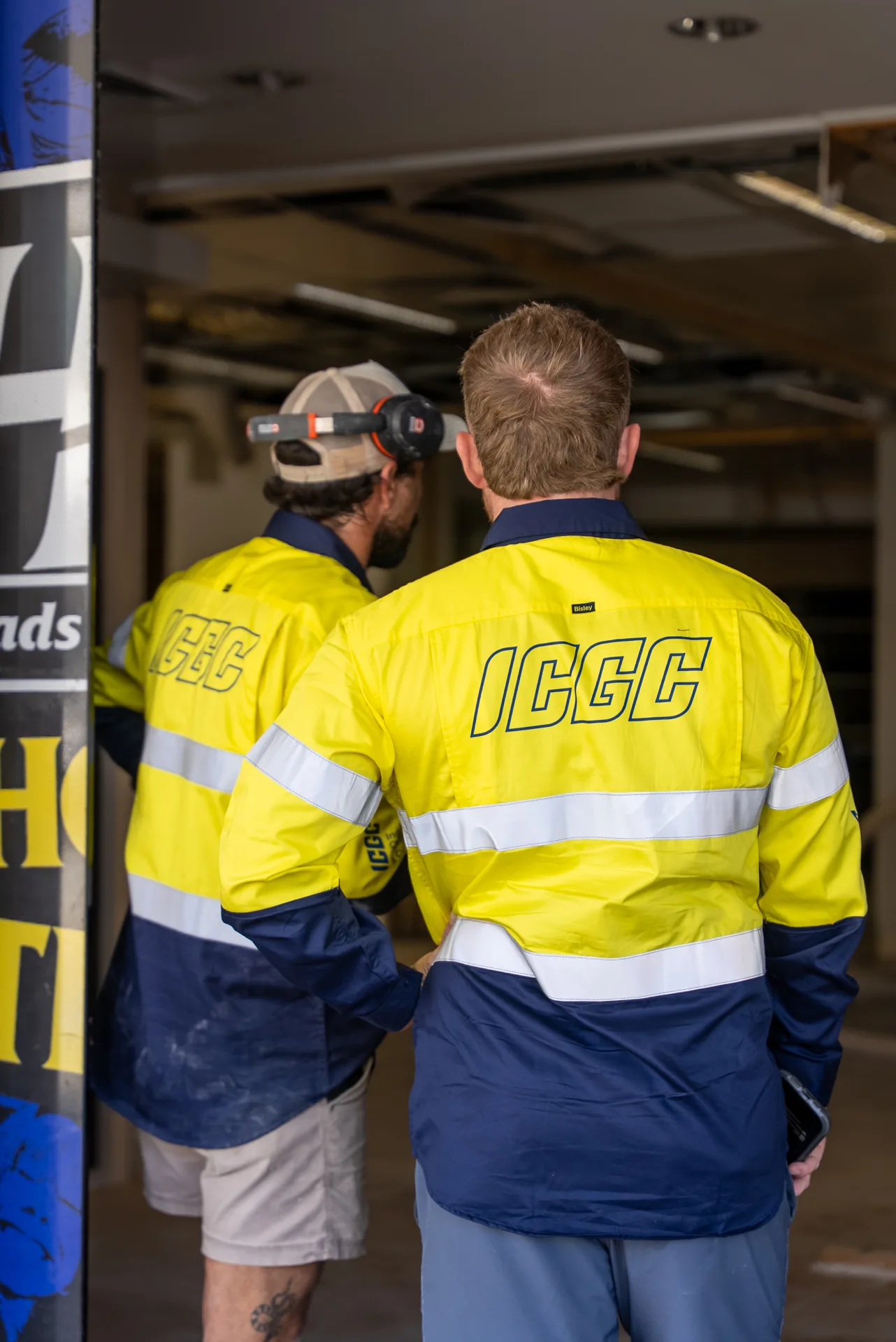 ICGC team member with edge grinder walking through a large open commercial space during concrete prep