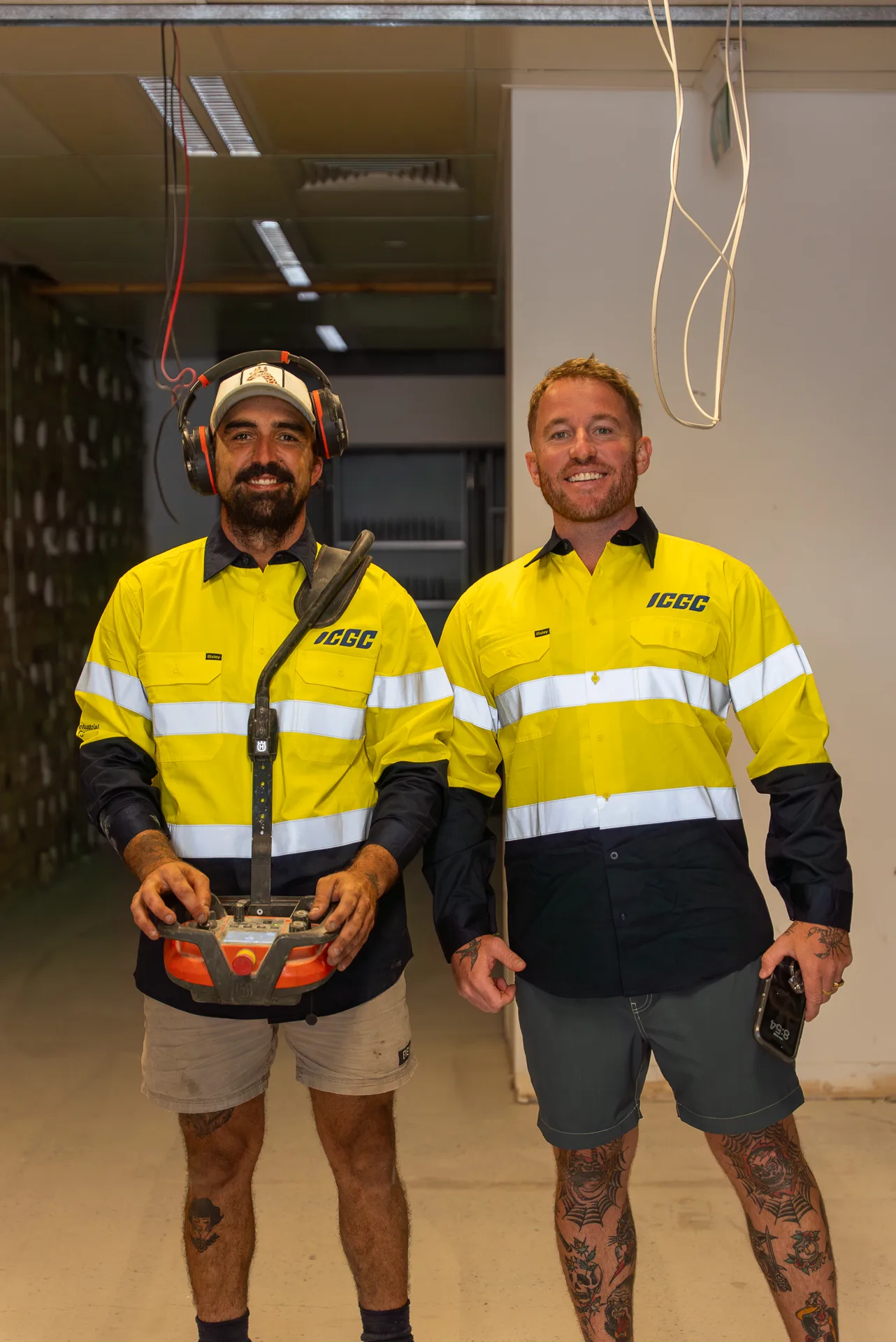 ICGC team members walking through a large commercial space being prepared for concrete grinding